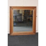 A pine framed rectangular wall mirror, mirror plate 62cm by 55cm