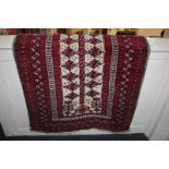 A Persian style wool prayer rug, with crimson and blue stylised floral centre on cream field,