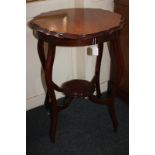 A Victorian circular side table with piecrust border, on cabriole legs with uniting stretchers and