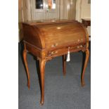 An Edwardian mahogany cylinder top writing desk with gilt metal gallery back and fitted interior
