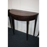 A 19th century mahogany demi lune fold-over top side table on four square tapered legs (a/f), 80cm