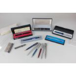 Six cased Parker fountain and ballpoint pens, other Parker pens, a white metal three-colour