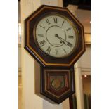 A Seth Thomas American drop-dial wall clock in octagonal shaped mahogany case, the circular enamel