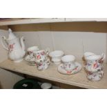 A Royal Albert porcelain tea set, decorated with red and purple flowers on white ground,