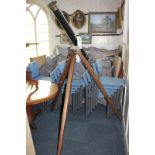 A large brass and black painted telescope mounted with sighting scope and two extra eyepieces, on