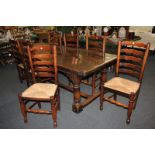 A matched set of eight ladderback dining chairs with rush seats and turned baluster front