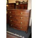 A 19th century mahogany bow-front chest of two short over three long drawers with brass knobs, on