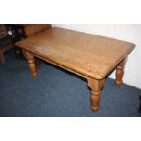 A rectangular pine coffee table on four turned baluster legs, 107cm