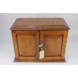 An oak pipe smoker's cabinet enclosing two drawers, 36.5cm