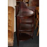 A mahogany corner whatnot with three bow shelves and raised shaped back, 104cm