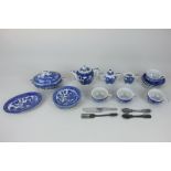 A 20th century Japanese porcelain doll's dinner and tea set in blue and white willow pattern,