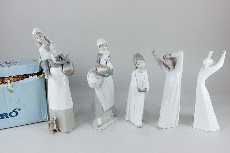 Four Lladro porcelain figures to include two ladies with baskets, one with puppy, 28cm, boxed, and