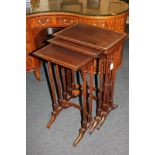 A nest of three rosewood side tables with turned supports, on trestle feet, 44.5cm