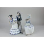 A Nao figure group of a couple in flamenco costume, 28cm, and another of a lady, 25cm