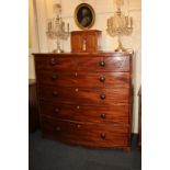 A George III inlaid mahogany bow-front chest of two short over three long drawers with knob