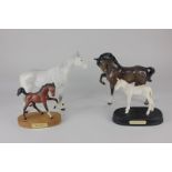 Three Beswick porcelain models of horses, Imperial (1557) in grey gloss, head tucked with leg up