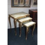 A nest of three giltwood side tables, rectangular serpentine sided tops, with Greek key patterned