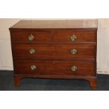 A George III mahogany flat-front chest of two short over two long drawers with circular embossed