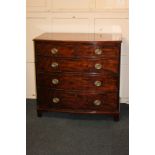 A 19th century mahogany bow-front chest of two short over three long drawers with oval brass