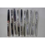 A set of ten William IV silver table knives with half demi-fluted handles, engraved armorial and
