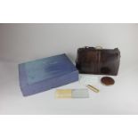 A Mappin & Webb lizard skin leather handbag containing a matching Kigu compact, a handbag mirror and