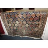 A Persian style wool rug with all-over pattern of floral botch motifs, on dark blue field with