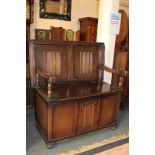 A 20th century oak monk's bench with rising top, on bun feet, 101cm