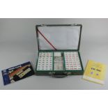 A Mahjong set in fitted case with original wrapping, together with two booklets on the game