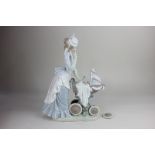 A Lladro porcelain figure of a women in Victorian dress pushing a baby in a pram (a/f - one wheel