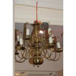 A Dutch style brass chandelier light fitting with ten scrolling branch light holders, 45cm