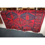 A Bokhara style rug with geometric design in reds and blues, 178cm by 147cm