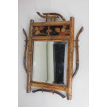 A small Japanese style wall mirror, with bamboo shaped frame and rectangular black lacquered panel