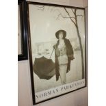 A framed Norman Parkinson reproduction photograph of a lady holding an umbrella, 79cm by 58.5cm