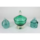 Two green glass dump inkwells together with a green glass pedestal bowl and cover 13.5cm diameter