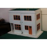 An Art Deco style white painted dolls house, with hinged two panel front enclosing four rooms,