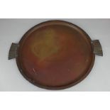 A Carl Sorensen Art Deco bronze circular tray with ridged handles, signed with impressed mark to