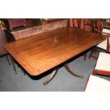 A mahogany rectangular breakfast table with crossbanded top, on pedestal support with three fluted