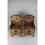 A pair of Arts & Crafts style oak miniature chairs with single drawer, 47cm high