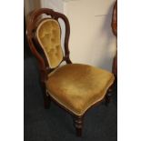A Victorian upholstered nursing chair, with button upholstered back, on turned and fluted legs