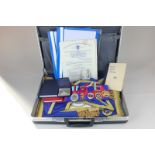 A collection of Freemasonry regalia, including two Sussex Lodge aprons, sashes, booklets and