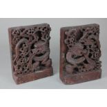 A pair of Chinese carved soapstone book ends decorated with dragons, 15cm