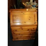 A Ducal pine bureau with fall front and three drawers with knob handles, 82cm