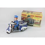 A boxed Nomura TN Toys tinplate toy police patrol auto-tricycle, battery operated, made in Japan (