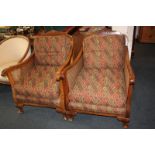 A pair of bergère cane lounger chairs, with cushions, on carved cabriole feet