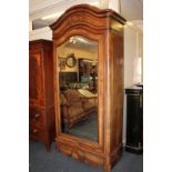 A Continental rosewood armoire, moulded arched top with single-mirrored door (repair required to