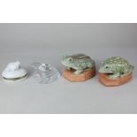 A Baccarat clear glass model of a toad, 7cm high, together with two similar porcelain models of