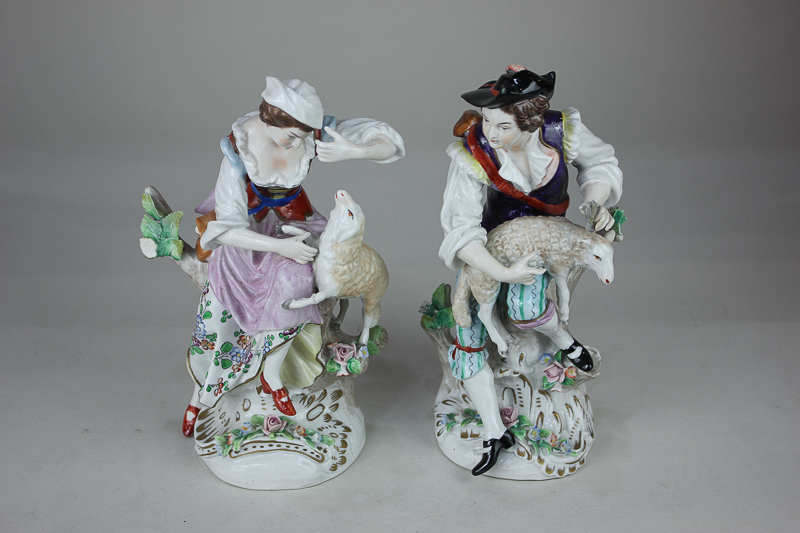 A pair of Sitzendorf porcelain figures of a shepherd and shepherdess, with applied floral