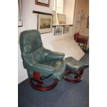 A green leather lounger armchair by Stressless, on a circular swivel base with adjustable back and