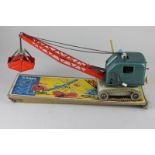 A Gama tinplate clockwork toy crane with caterpillar tracks, part box, 42cm