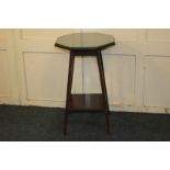 A mahogany octagonal side table, with loose glass covered top, on sloping legs with platform